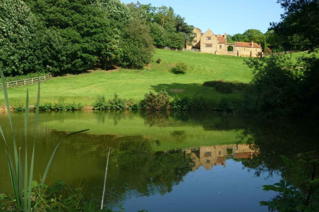Heath Farm Holiday Cottages reflection in the lake