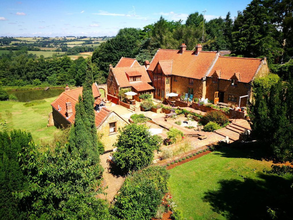 Heath Farm Holiday Cottages Courtyard with views of rolling Cotswold Hills